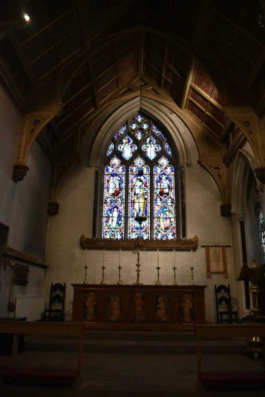 a church with stained glass windows and a bench