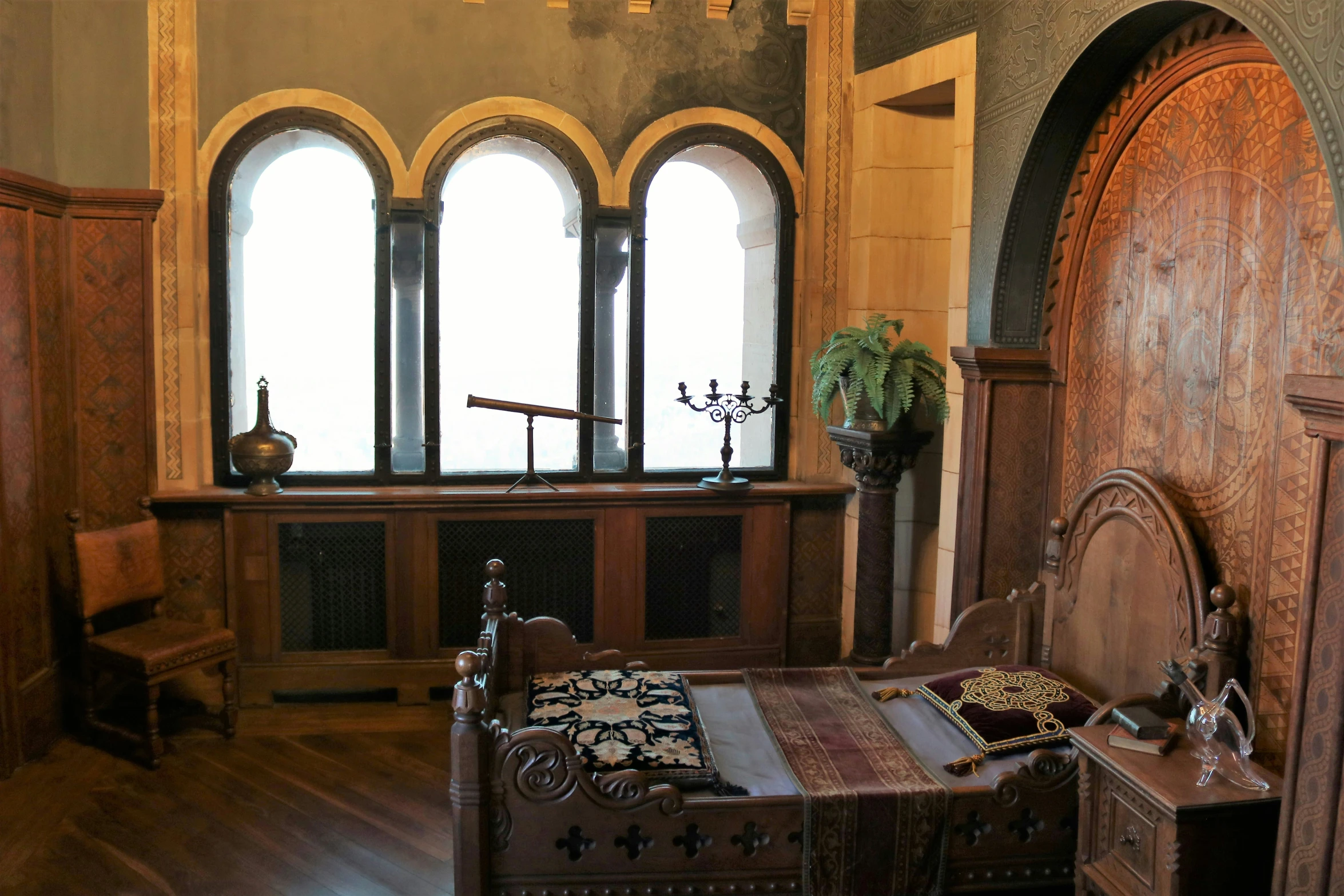 a large, empty bedroom with wooden floors and two windows