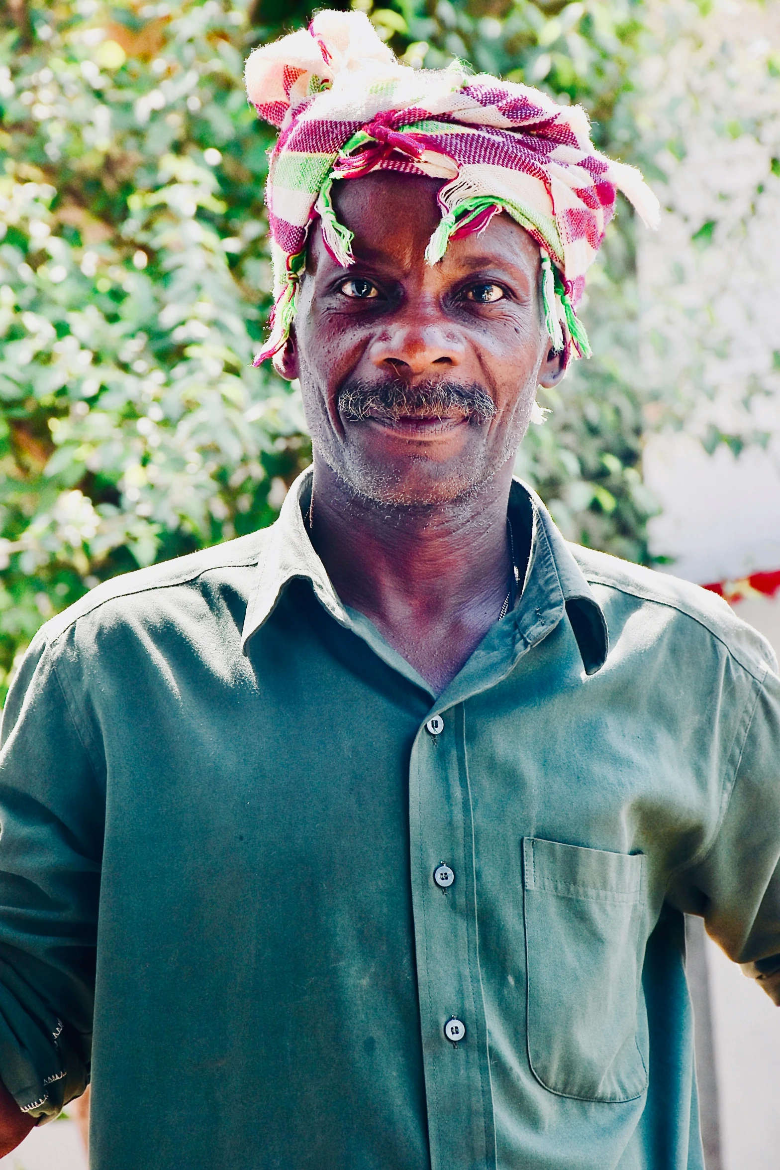 a person wearing a hat has a pipe in his mouth