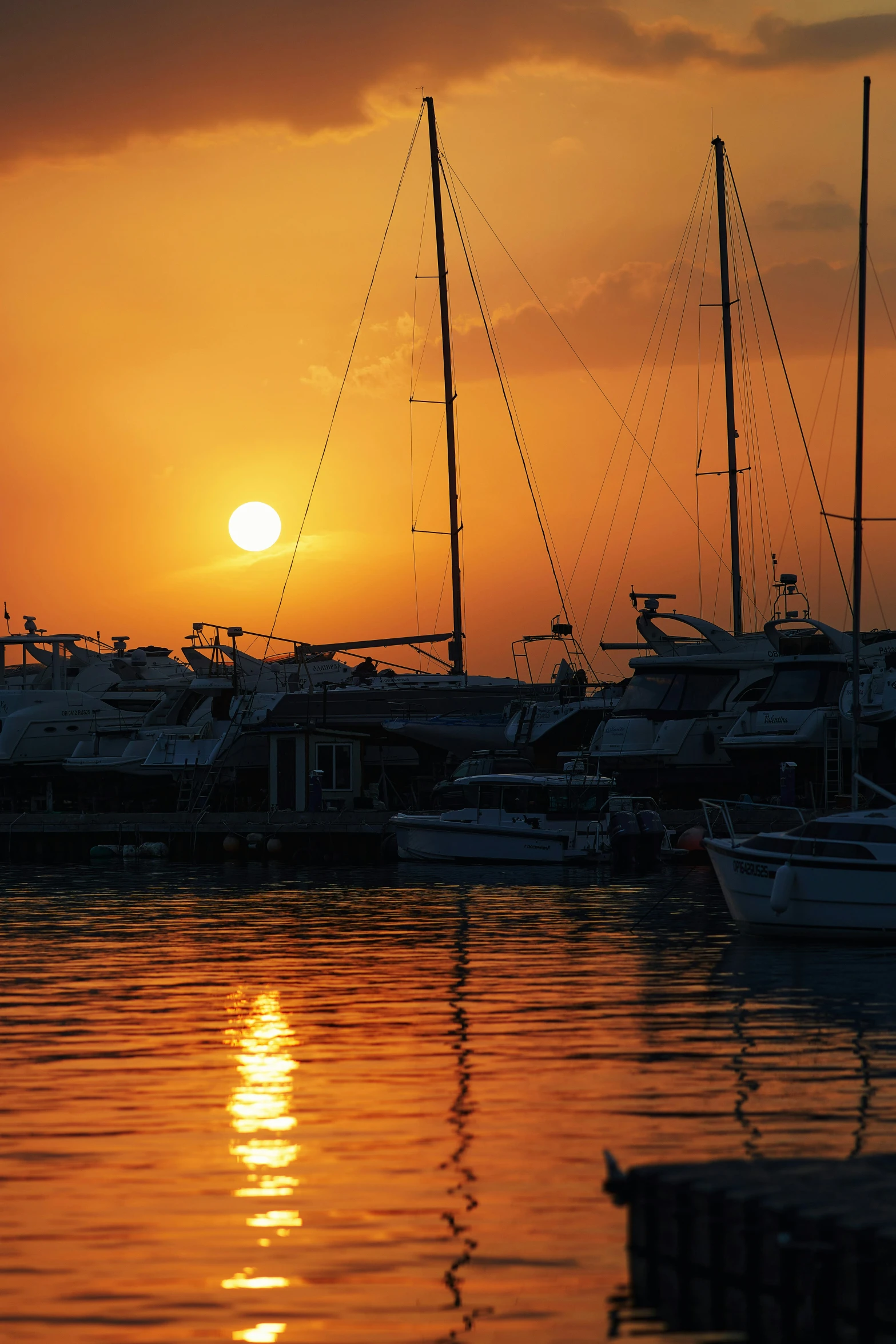 boats sit on the water at sunrise in the bay