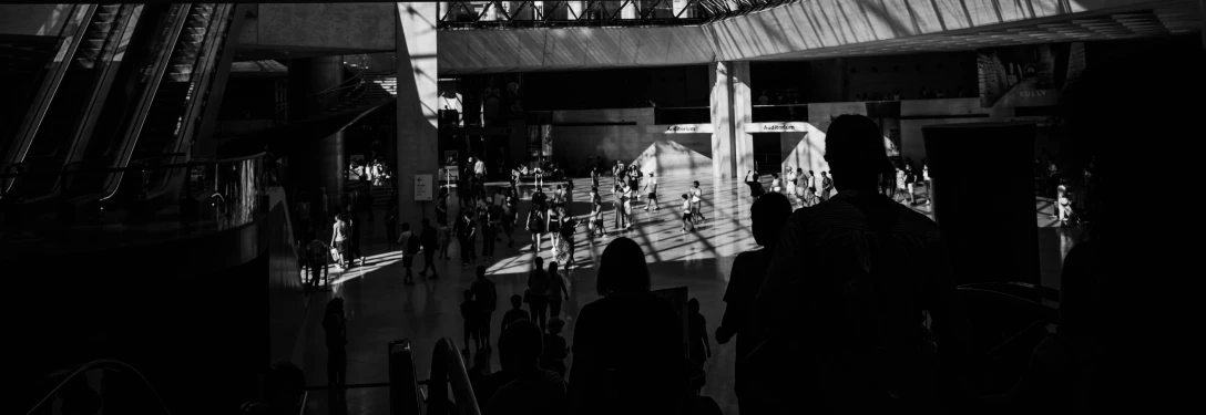 a dark image of some buildings and people