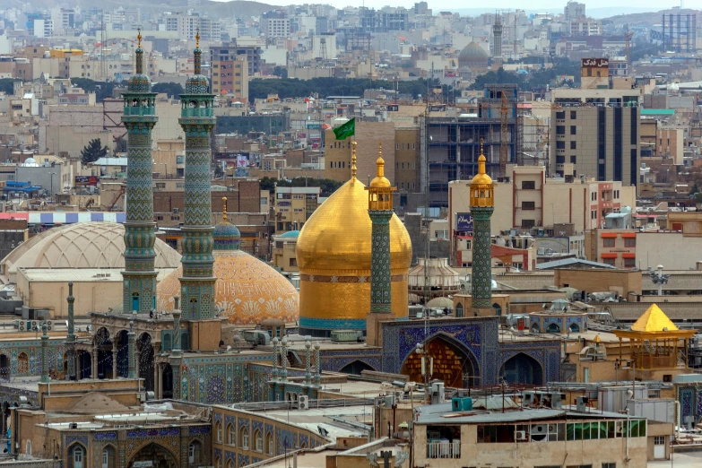 two gold domes in an old city setting