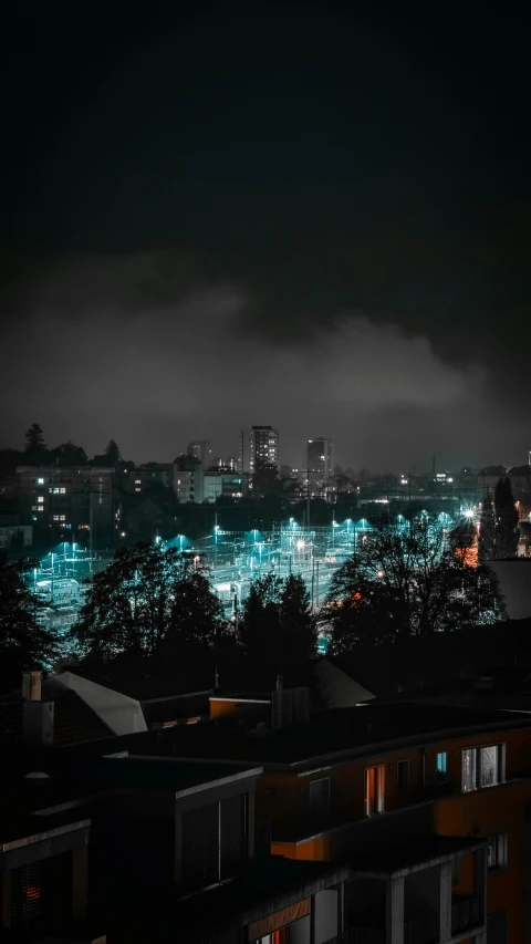 a nighttime scene with city lights as clouds move past