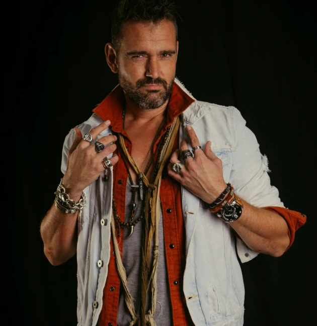 a man in an orange vest poses for the camera