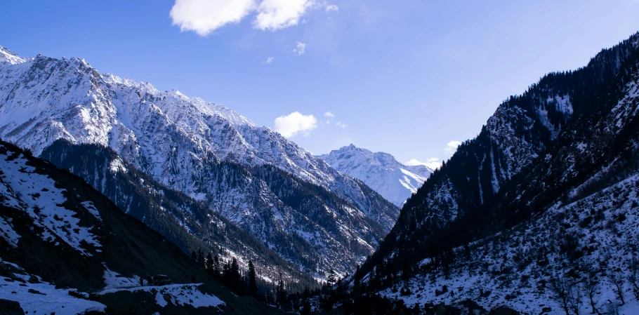 a snowy mountain landscape under a cloudy sky