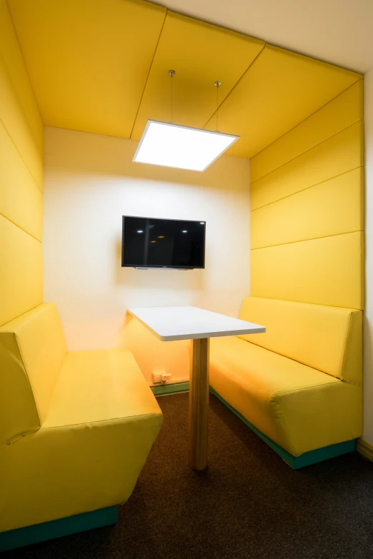 small white table with yellow furniture in a brightly lit room