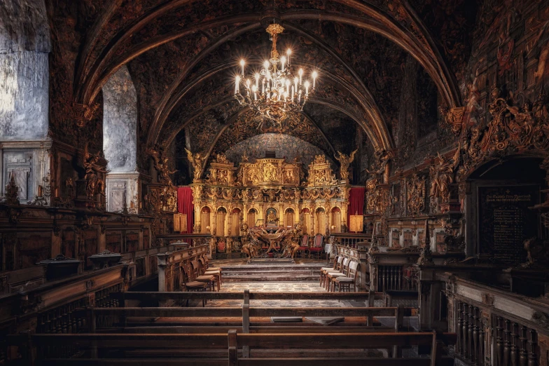 a church with a chandelier and a wooden alter