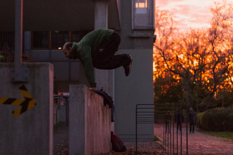 a man doing skateboard tricks on a wall