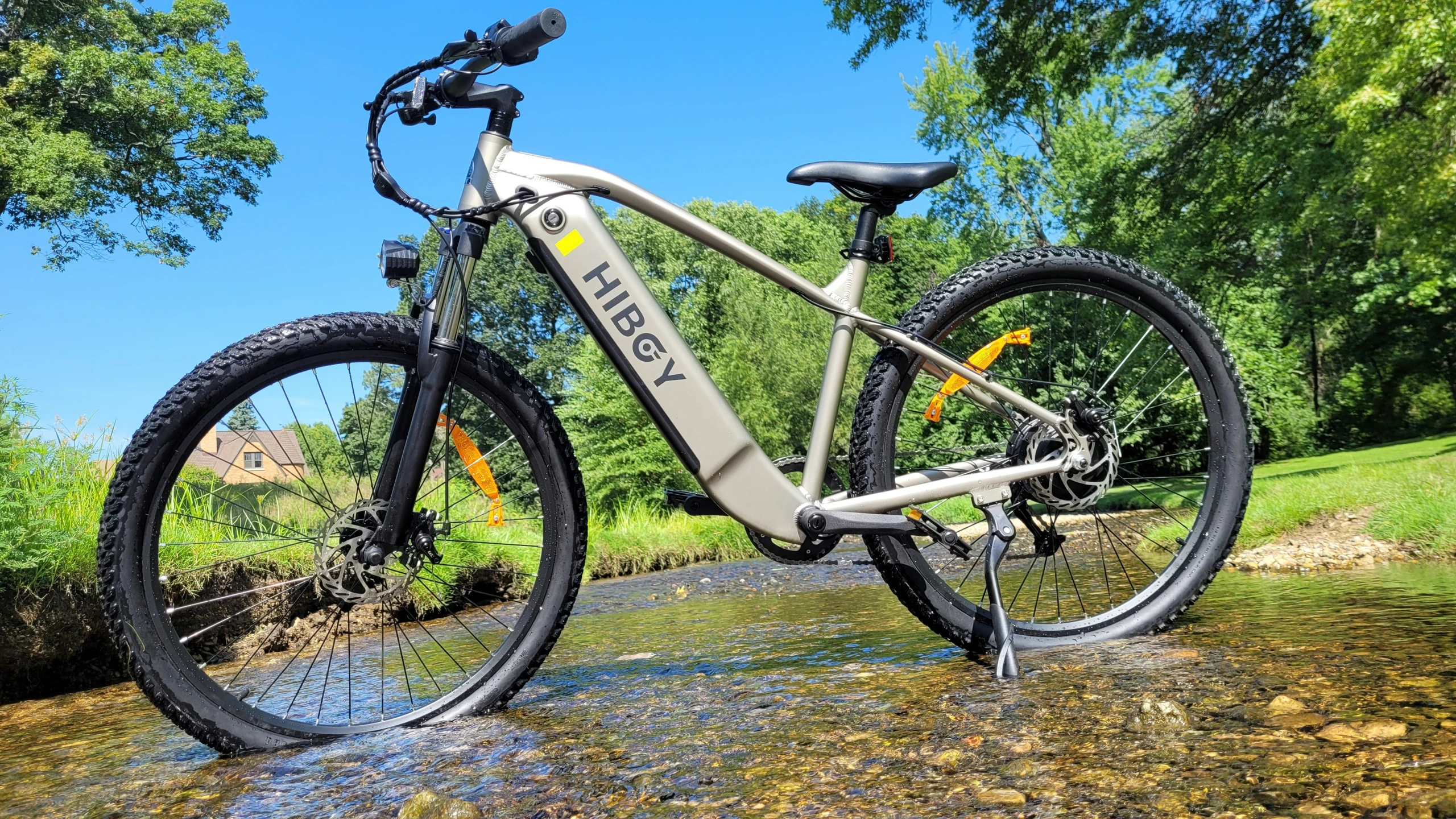 a bicycle leaning up on the side of a muddy stream