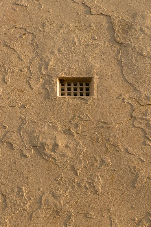 a drain in the side of a sandy beach