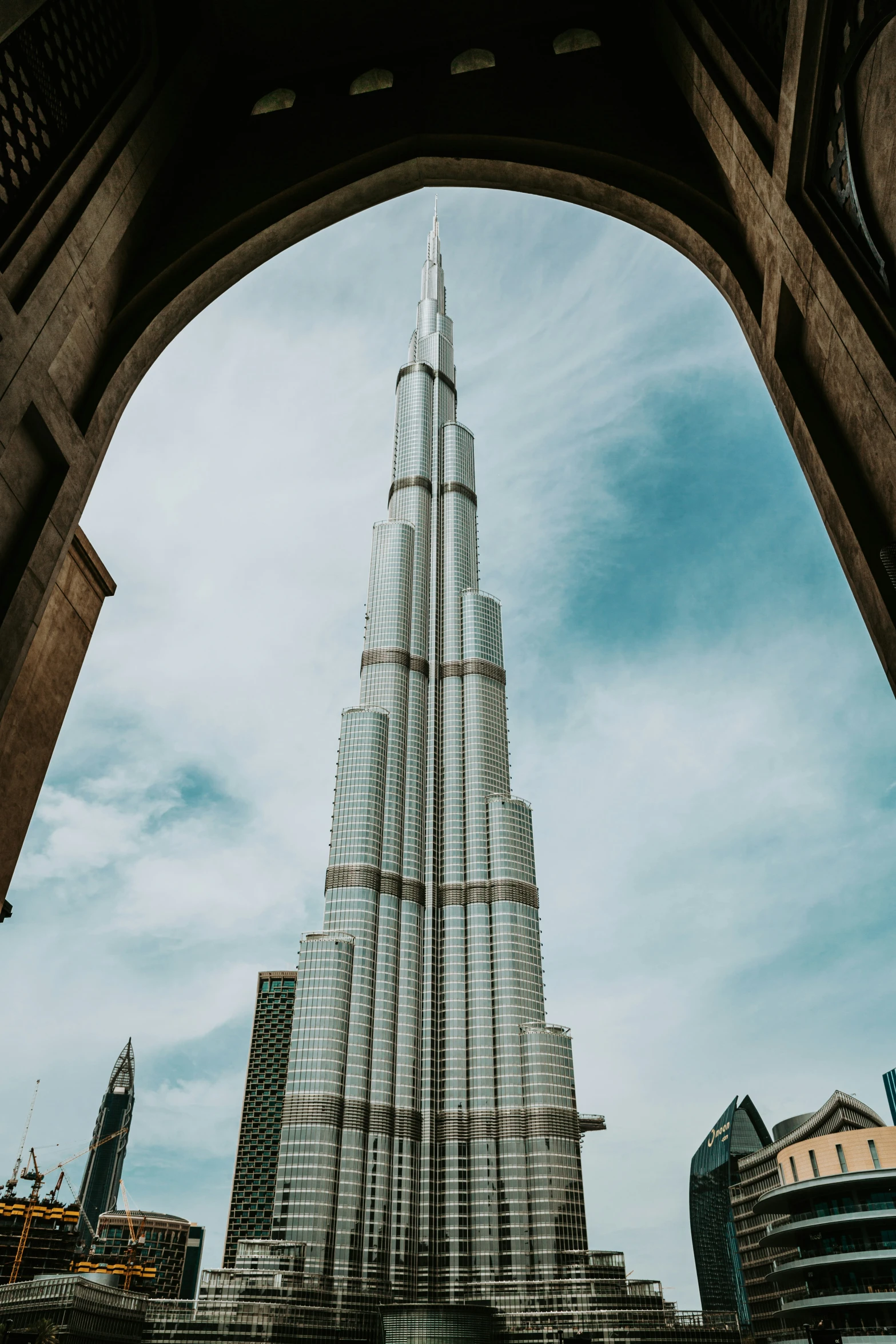 a building with a tower stands in the middle of a city