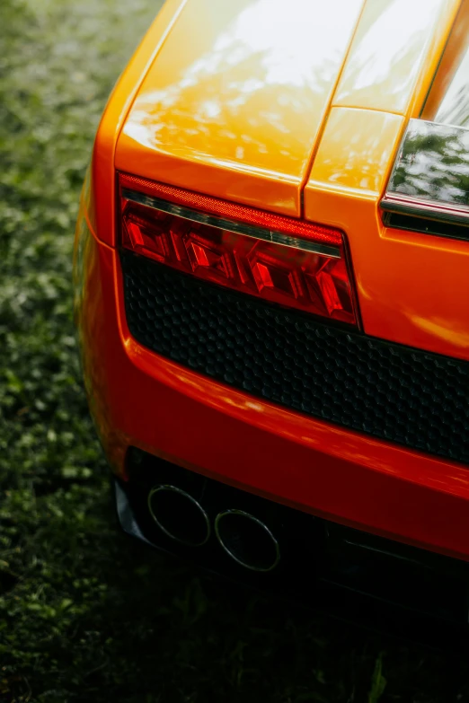 the tail end of an orange sports car
