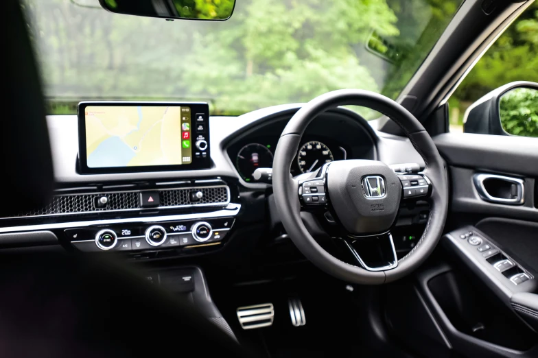 the car's dashboard has the steering wheel visible and an in - dash entertainment system