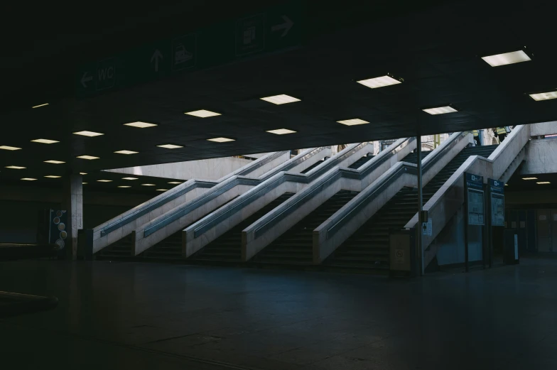 a very big escalator in the city with stairs up