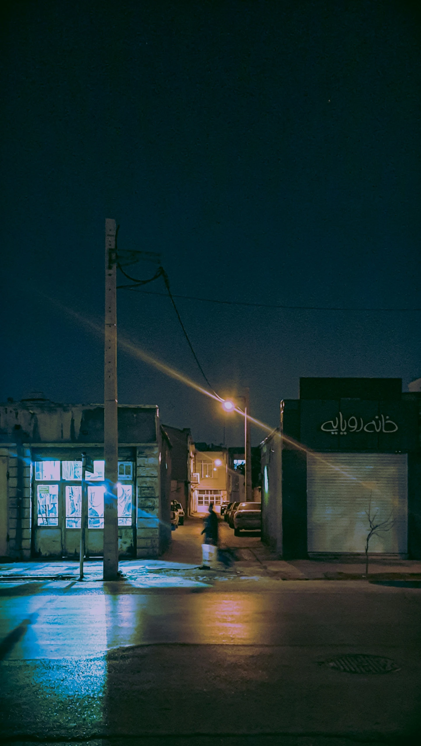 a car parked on the side of a street at night