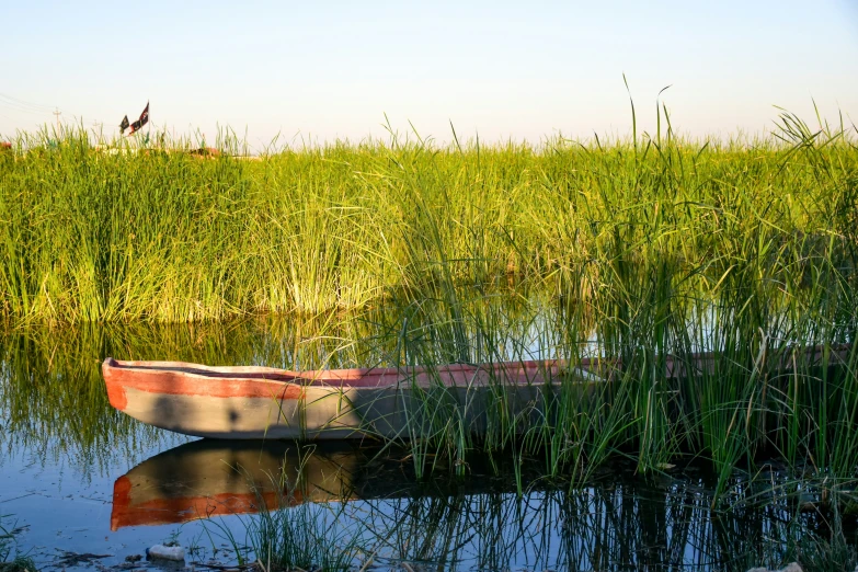 a small boat floating on top of a lake