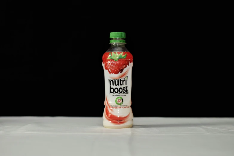 a bottle of fruit booster with strawberry on the inside