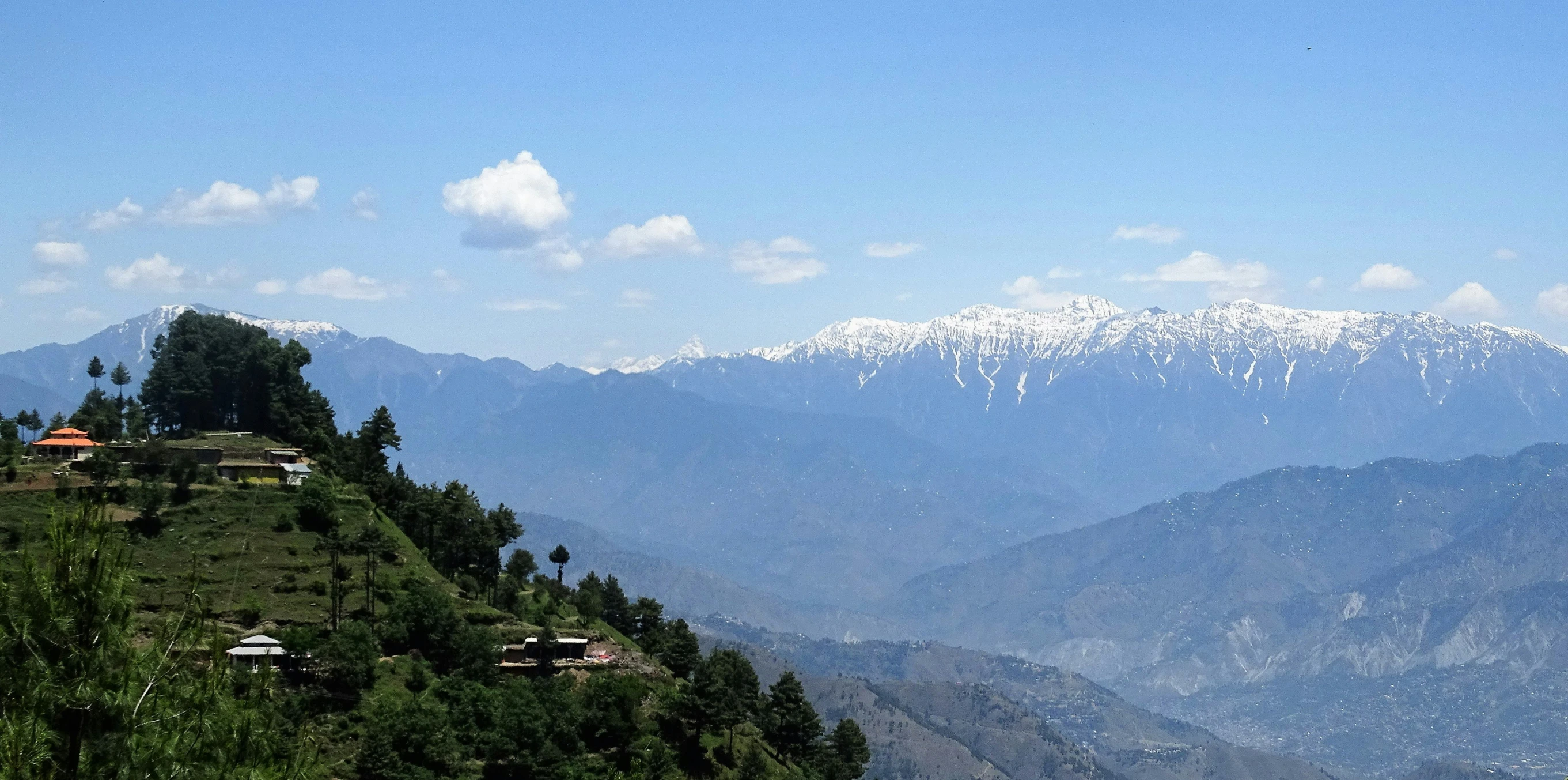 a mountain with snow covered mountains in the background