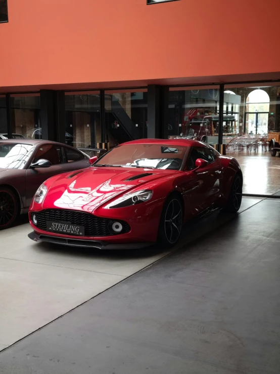 some pretty red cars parked near one another