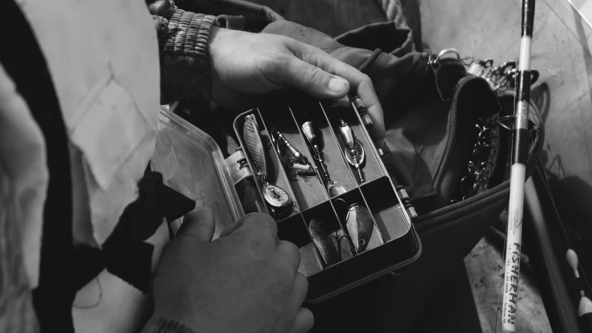 a person holding some small metal object near another person