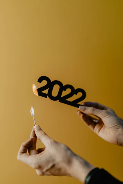 two people holding toothbrushes with the numbers 2012 on them