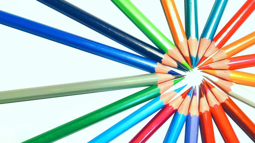 colorful pencils arranged in the center of a spiral of colors