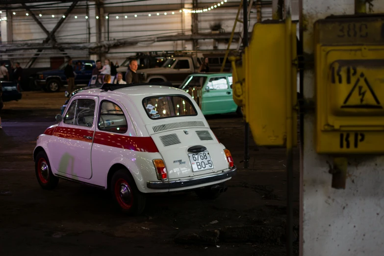 an old pink and white volkswagen type car