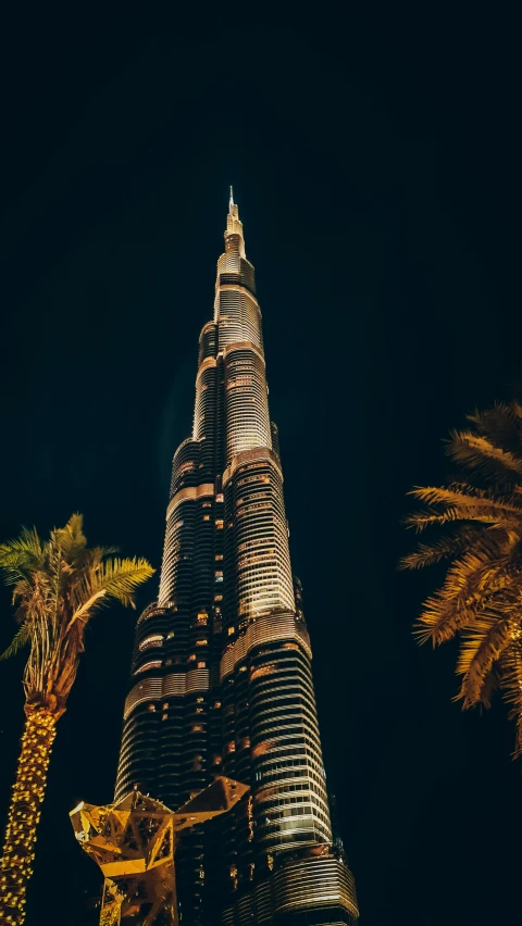 the top part of the burjdah tower lit up at night