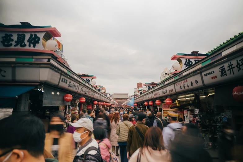 a group of people walking through a market