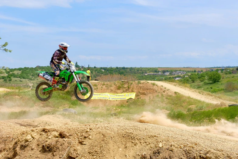 a motorcyclist is doing a jump on the dirt bike