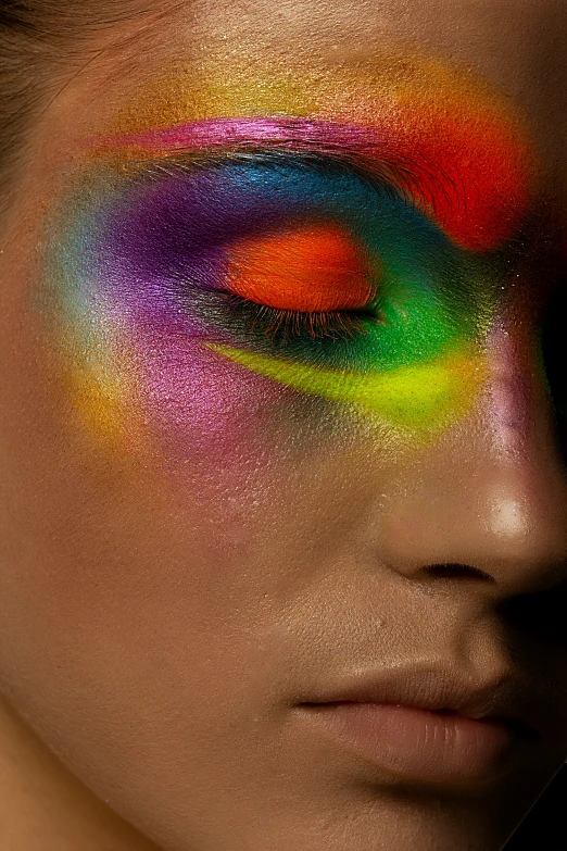 a woman has a bright colorful makeup on her face