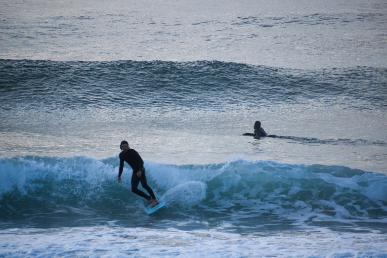 two people surfing on the waves in the ocean