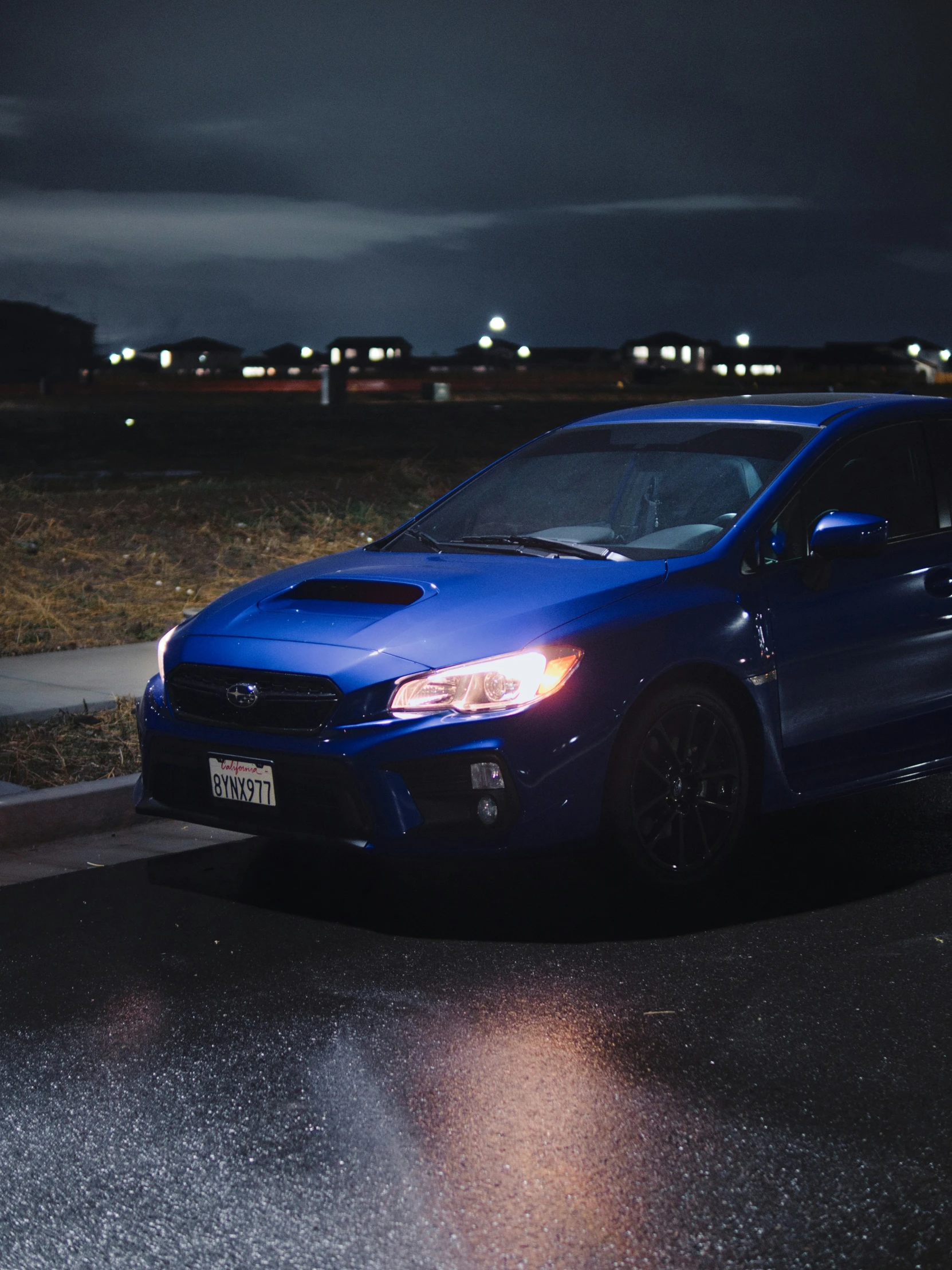 a blue car is parked near the road