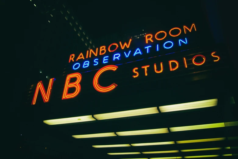 the neon sign outside rainbow room observation in a city