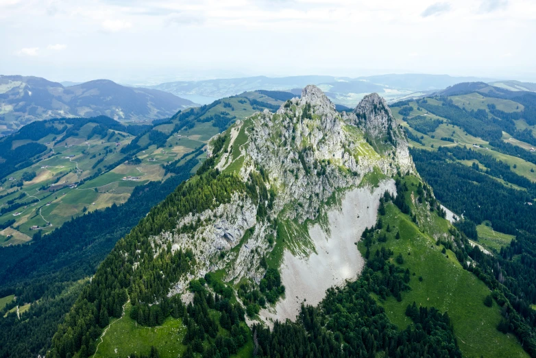 a large mountain with mountains in the background