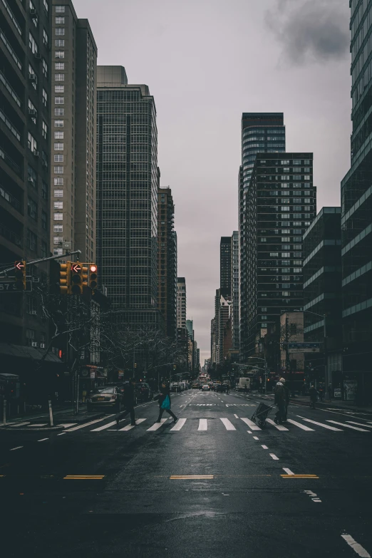 a city street with buildings and one person on the side