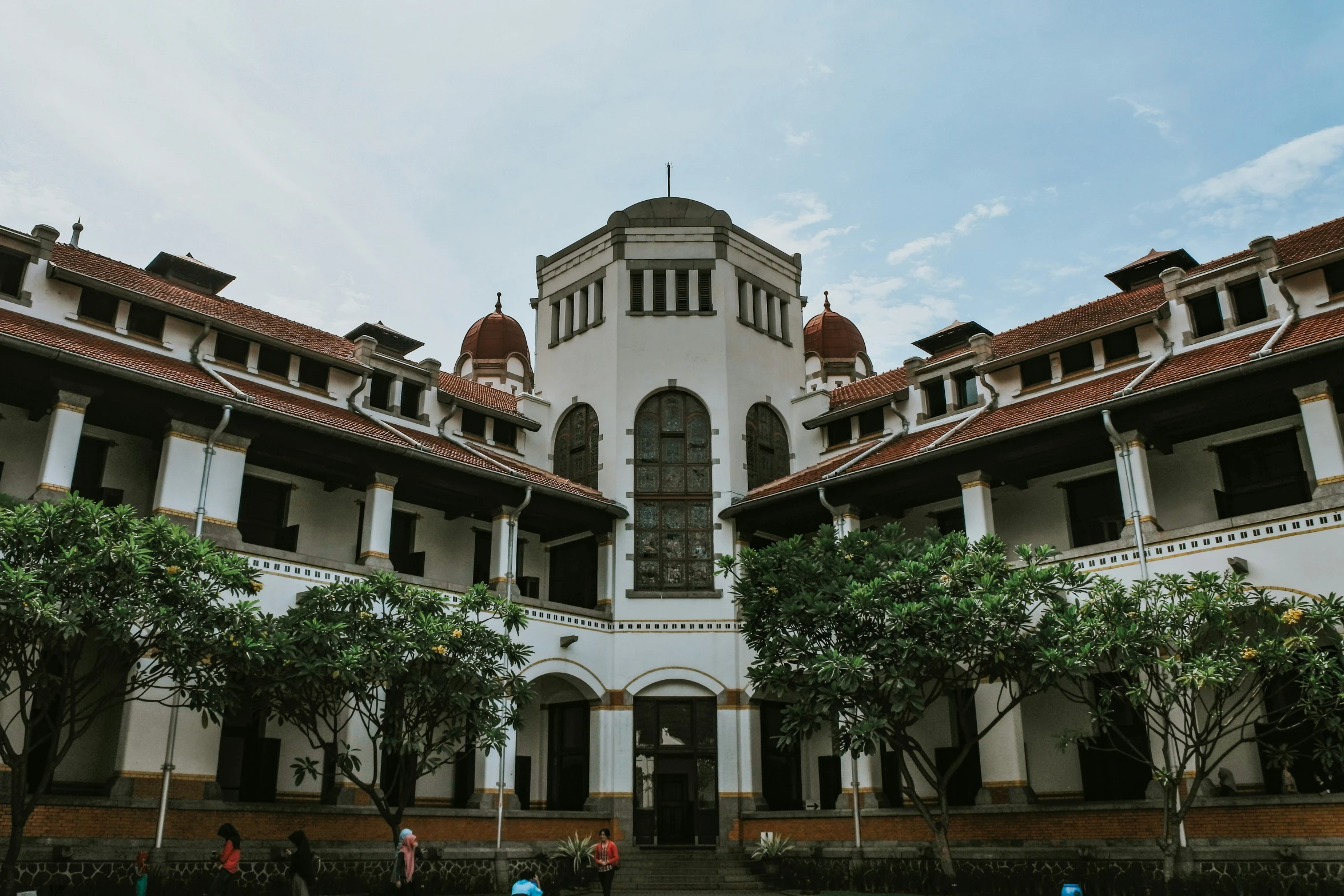 many people are outside a large building