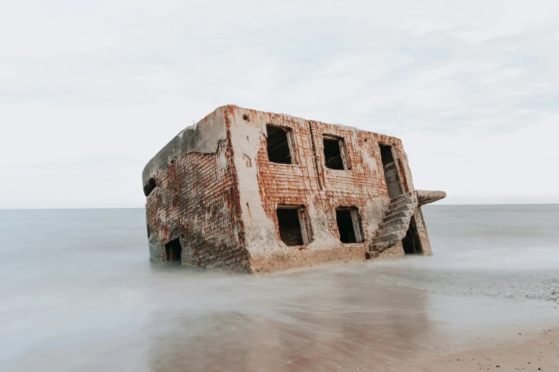 a brick structure has been washed out on the beach