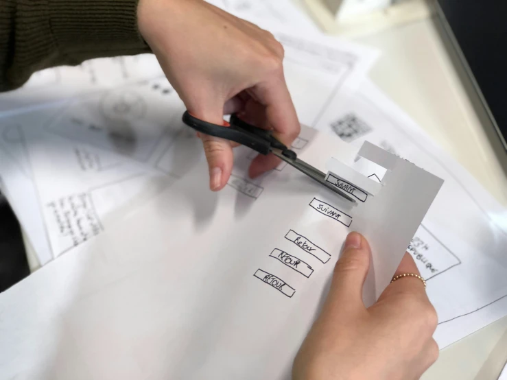 woman using creazers to place numbers in the box