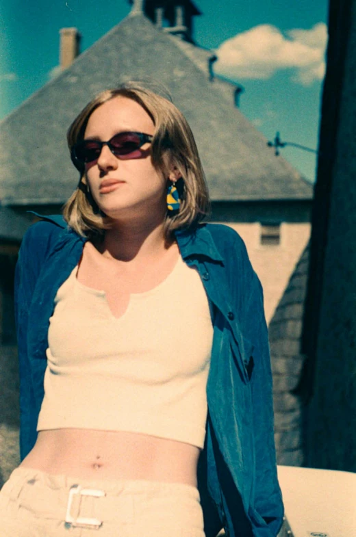 a woman standing on top of a roof near a street