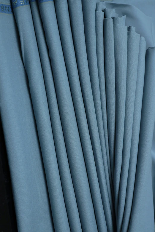 the blue sheets of a bed spread folded up