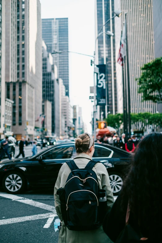 a man in the street is holding a backpack