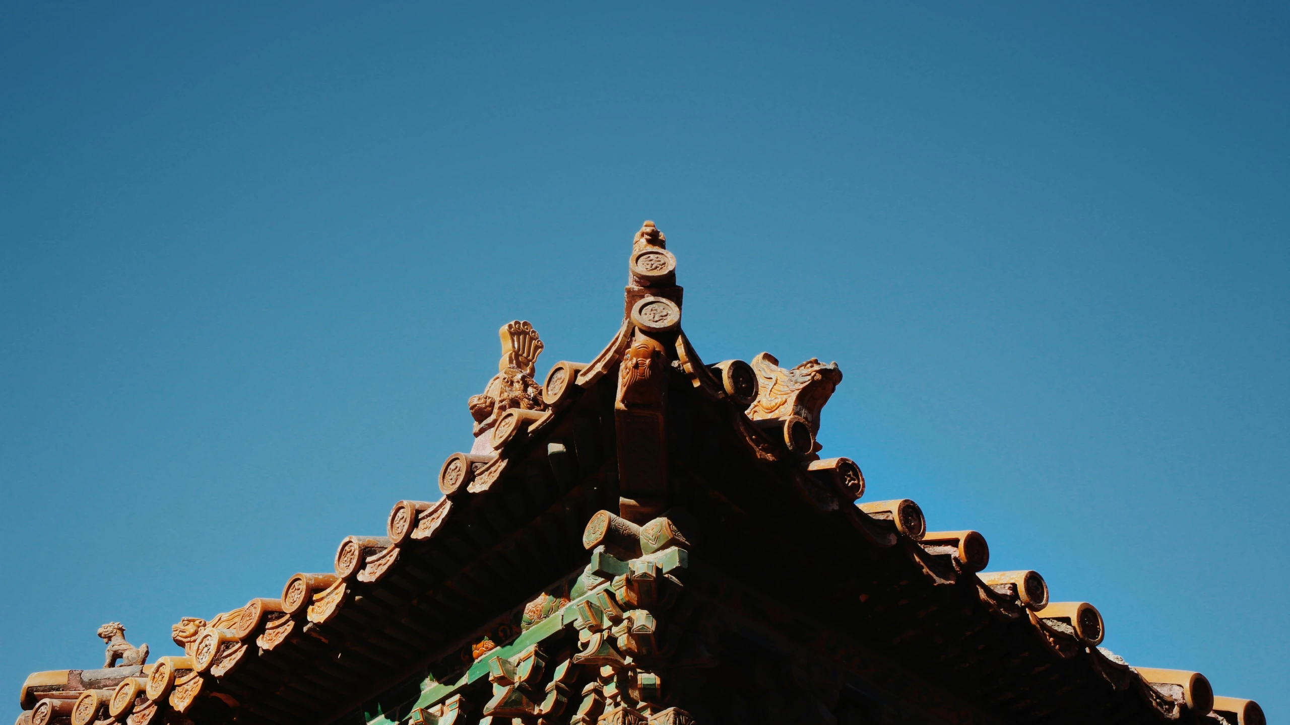 a tall clock tower next to a blue sky