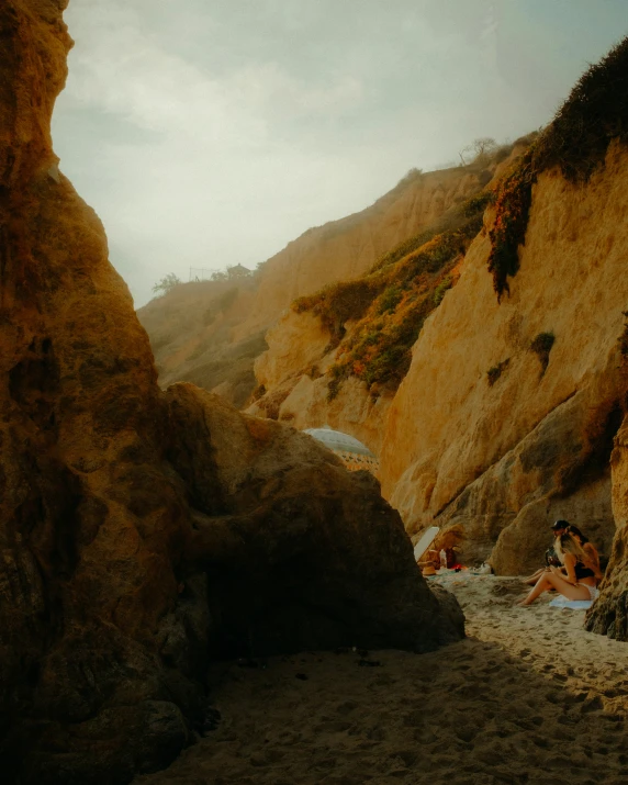 some people are laying on the rocks on the beach