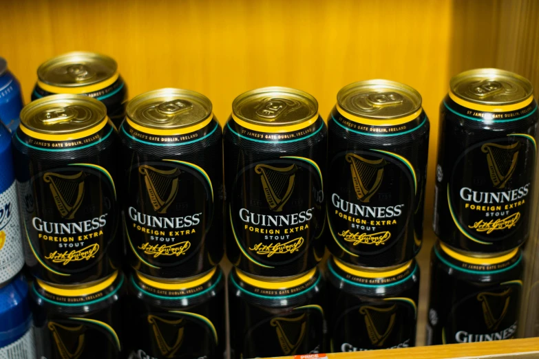 there are guinness cans in this shelf that is full