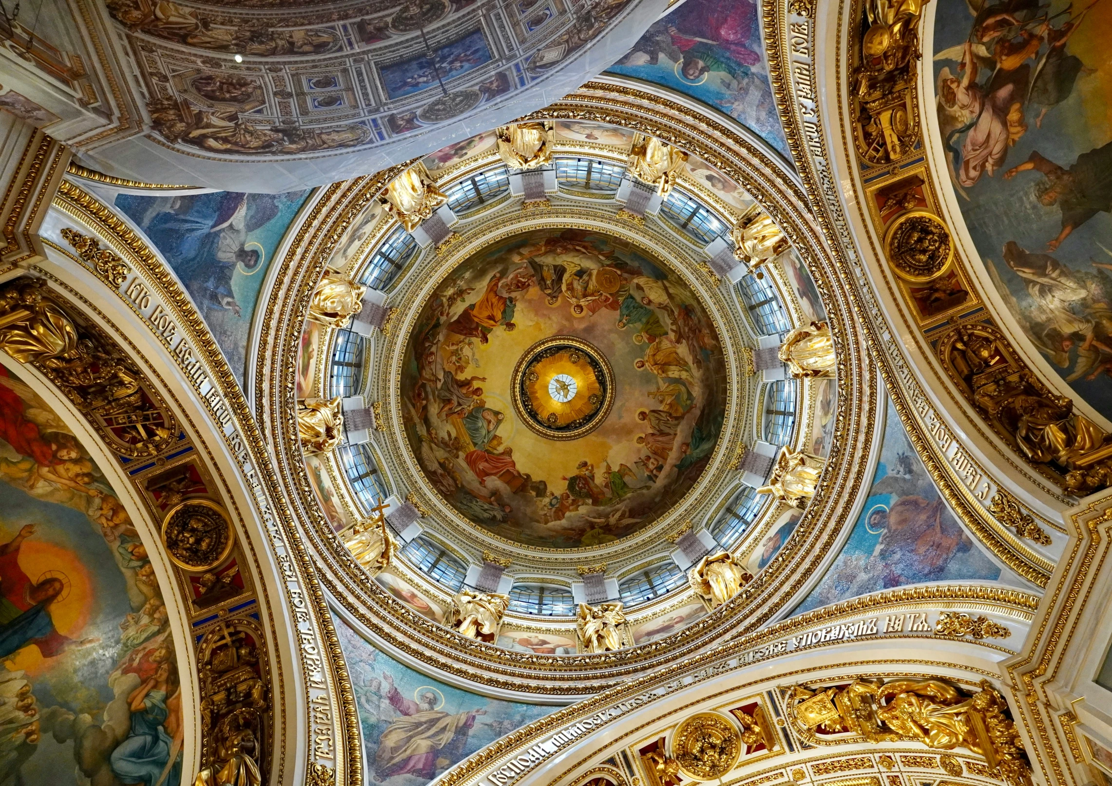 the ceiling of the church has a massive painting on it