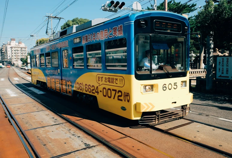 an empty trolley train car is making it's way down the tracks