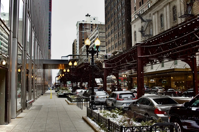 a city street with many vehicles parked on the street and a building