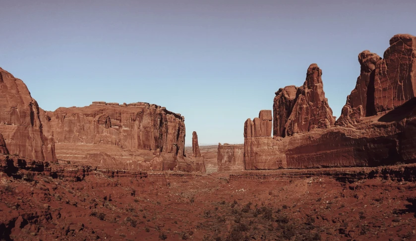 a view of the desert with very tall rocks