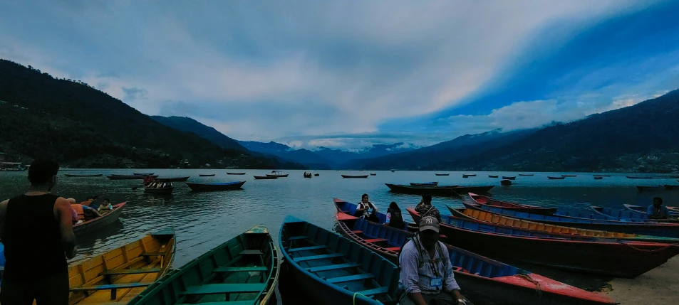 people are standing at the end of the boats